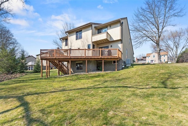 rear view of house featuring stairway, a yard, and a wooden deck