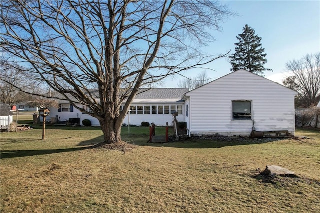 exterior space featuring a yard and a sunroom