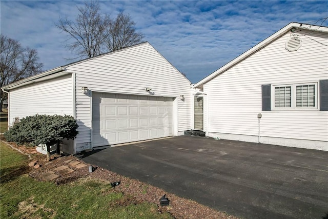 garage featuring aphalt driveway