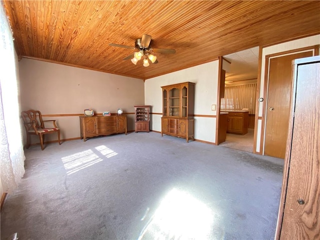 empty room featuring light carpet, wood ceiling, and a ceiling fan