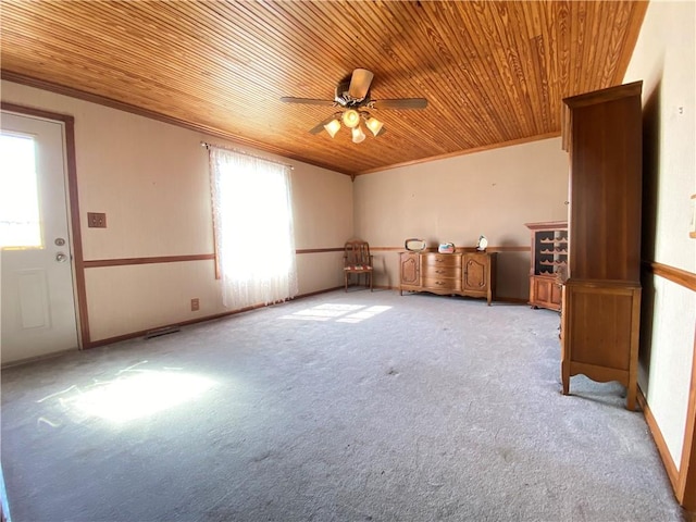 empty room with a ceiling fan, light carpet, wood ceiling, and ornamental molding