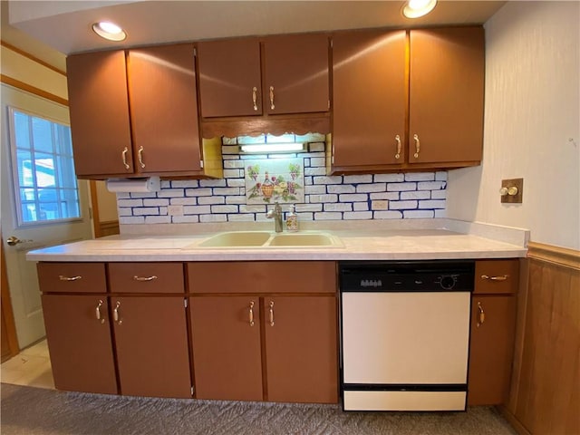 kitchen featuring a sink, backsplash, dishwasher, and light countertops