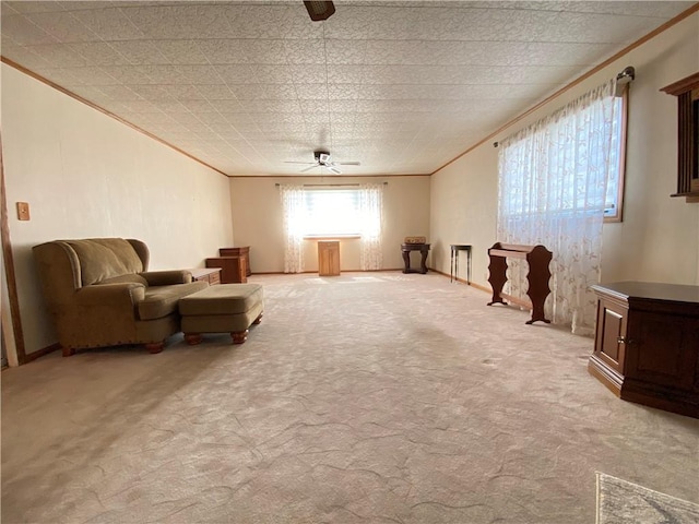 living area featuring light colored carpet, crown molding, and a ceiling fan