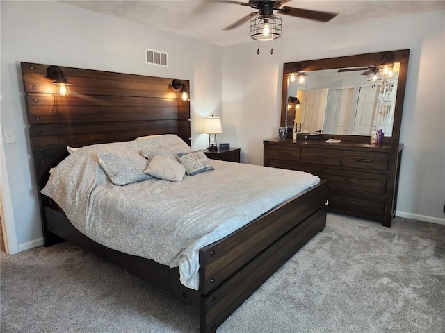 bedroom with visible vents, baseboards, and light colored carpet