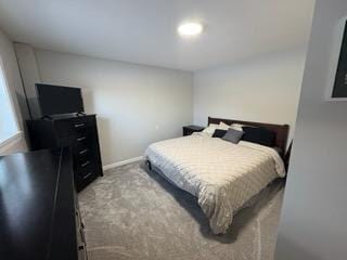 carpeted bedroom featuring baseboards