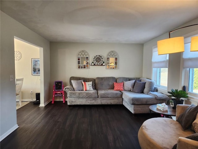 living area featuring dark wood finished floors and baseboards