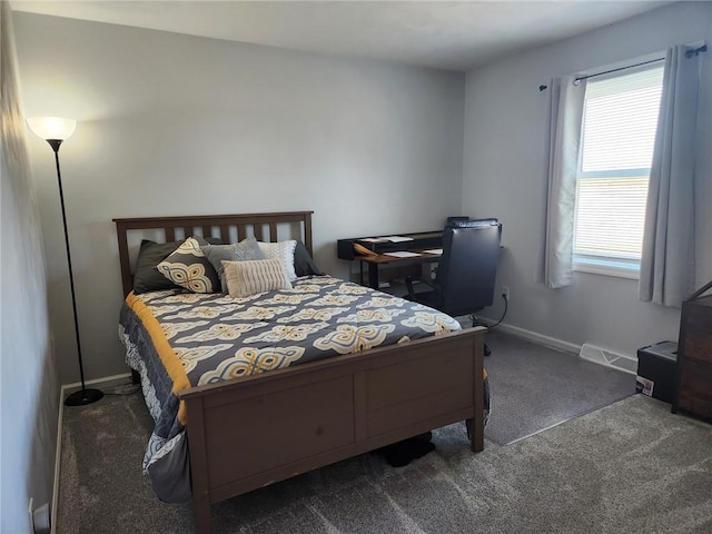 carpeted bedroom featuring visible vents and baseboards