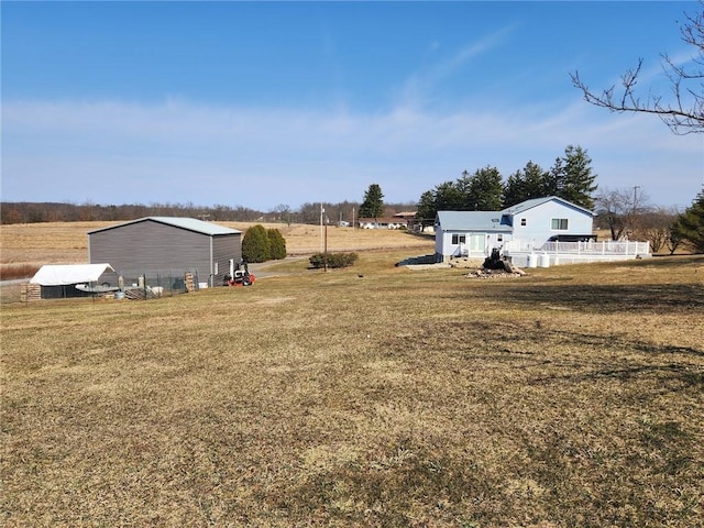 view of yard featuring an outdoor structure and a rural view