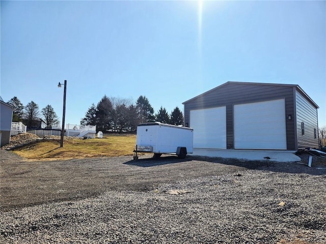 exterior space with a garage and an outdoor structure