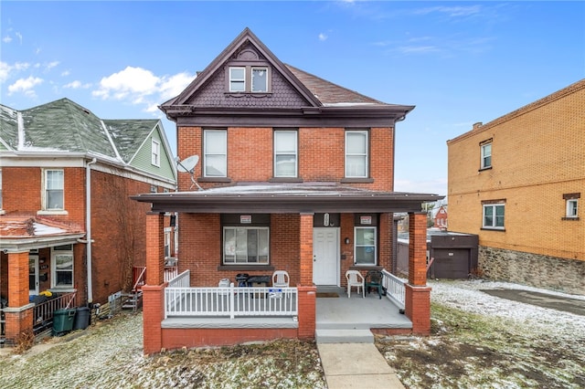 view of front of home with brick siding and covered porch