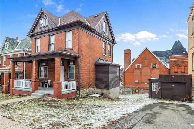 view of front of house with brick siding and covered porch