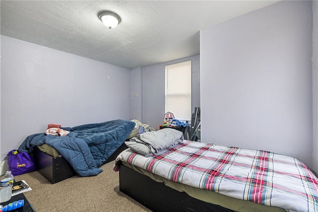 carpeted bedroom with a textured ceiling