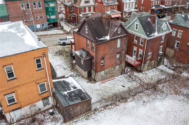 snowy aerial view featuring a residential view