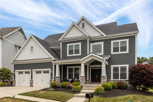 craftsman-style house with stone siding, board and batten siding, driveway, and a standing seam roof