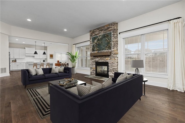 living area with visible vents, baseboards, recessed lighting, a fireplace, and dark wood-style flooring