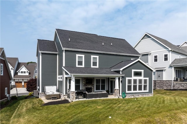 back of house with a hot tub, central air condition unit, an outdoor hangout area, a yard, and a patio area