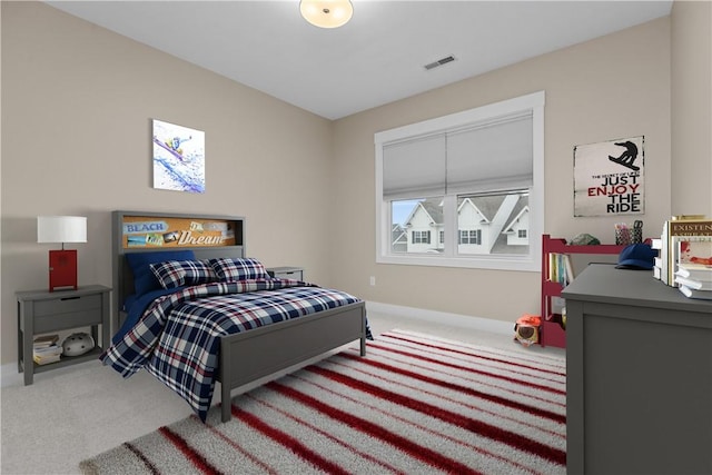 carpeted bedroom featuring visible vents and baseboards