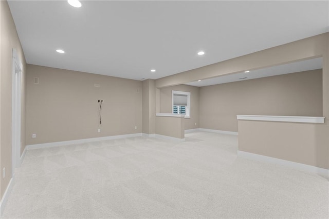 unfurnished room with recessed lighting, baseboards, and light carpet