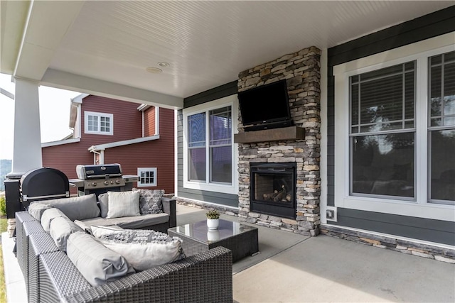 view of patio / terrace with an outdoor living space with a fireplace and grilling area