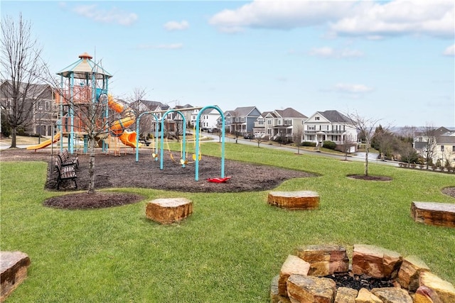 communal playground with a residential view and a lawn