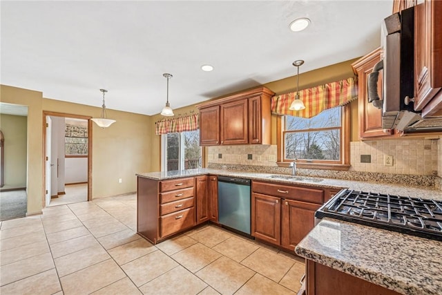 kitchen featuring a peninsula, a sink, dishwasher, decorative light fixtures, and brown cabinets