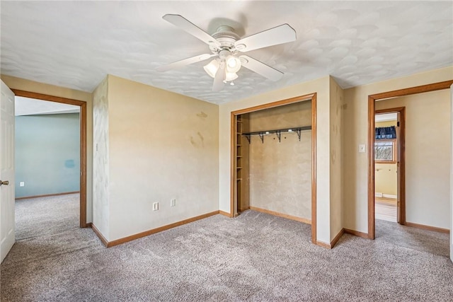 unfurnished bedroom with a closet, baseboards, ceiling fan, and carpet flooring