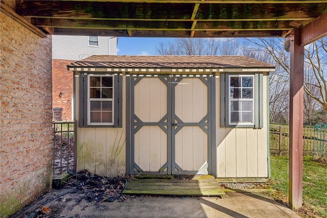 view of shed featuring fence