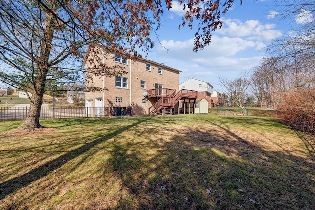 view of yard with a storage shed, an outbuilding, stairs, and fence