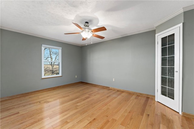 unfurnished room featuring light wood-type flooring, a textured ceiling, ornamental molding, and a ceiling fan