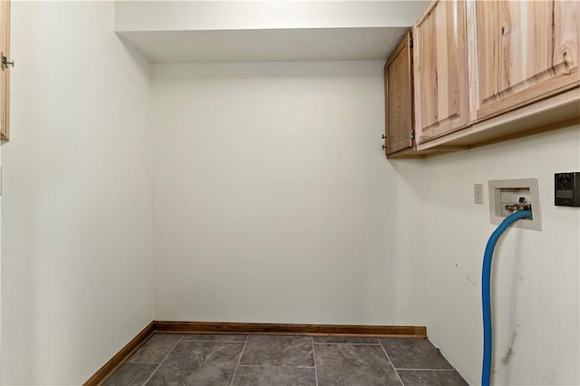 clothes washing area with baseboards, cabinet space, and hookup for a washing machine