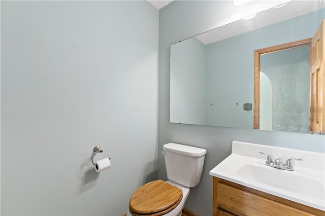 bathroom featuring toilet and vanity