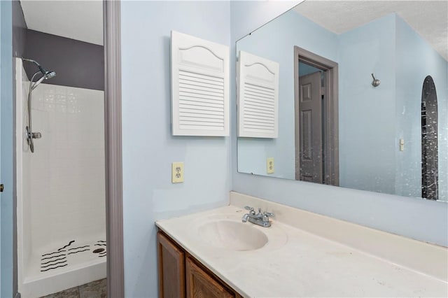 bathroom featuring a stall shower and vanity