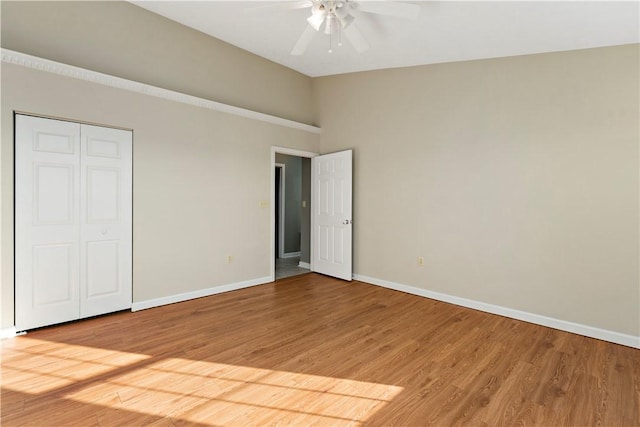 unfurnished bedroom featuring light wood-style flooring, baseboards, and ceiling fan