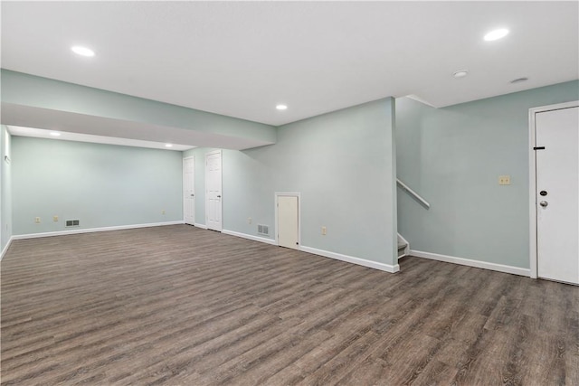 finished basement featuring visible vents, baseboards, stairs, recessed lighting, and wood finished floors