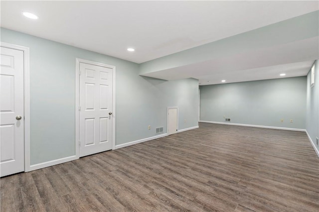 finished basement featuring visible vents, recessed lighting, baseboards, and wood finished floors