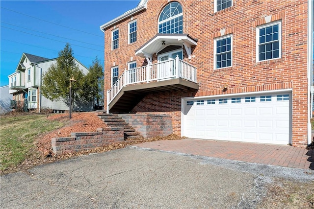 view of front of property with brick siding, driveway, and a garage