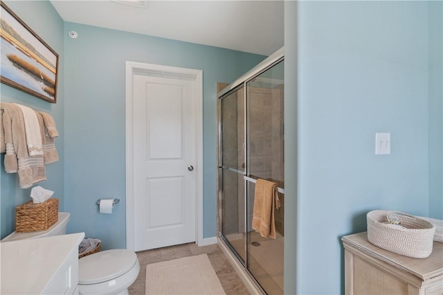 full bathroom featuring toilet and a stall shower