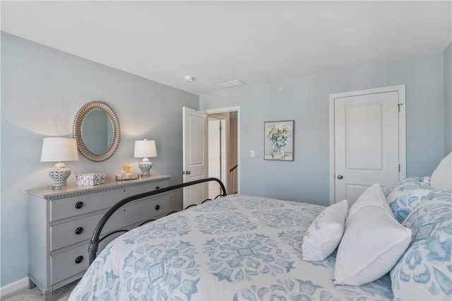 bedroom featuring visible vents and baseboards