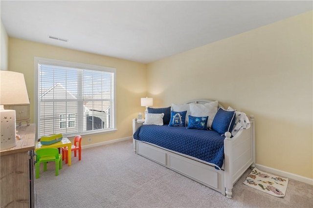 carpeted bedroom featuring visible vents and baseboards