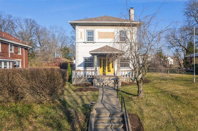 view of front of property featuring stucco siding, a chimney, a front yard, and a shingled roof