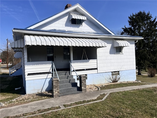 bungalow featuring covered porch and stairs