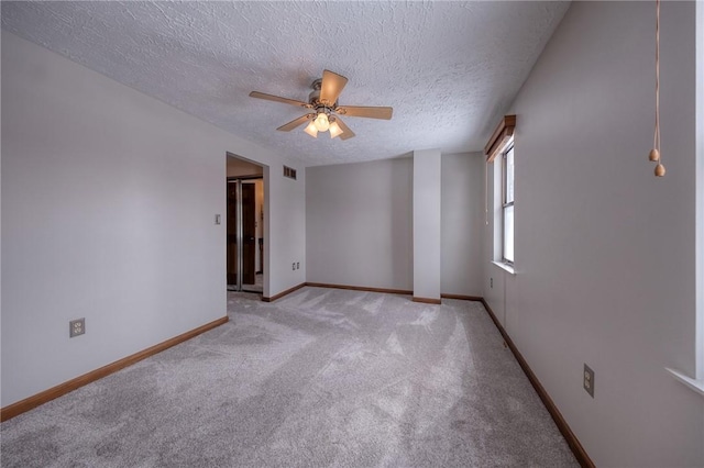 unfurnished room featuring light carpet, visible vents, a textured ceiling, and baseboards