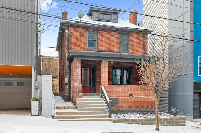 traditional style home featuring entry steps, a garage, and brick siding