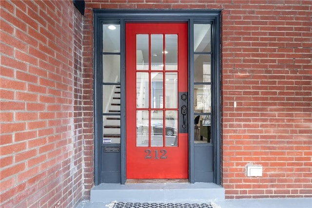 property entrance featuring brick siding