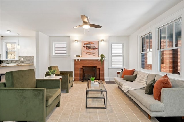 living room with a fireplace and a ceiling fan