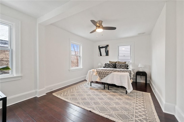 bedroom featuring baseboards, visible vents, dark wood-style flooring, and ceiling fan