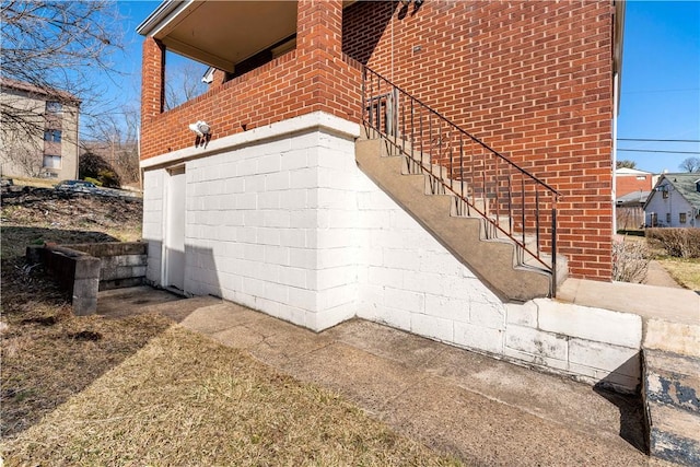 view of property exterior with brick siding