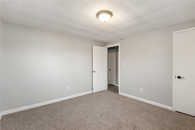 interior space with carpet flooring and baseboards