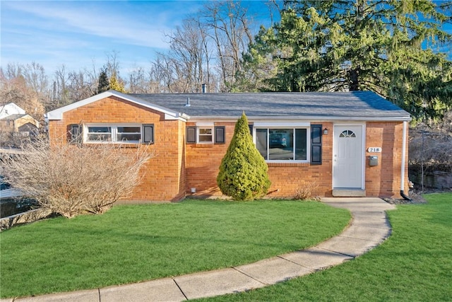 ranch-style home with a front yard and brick siding