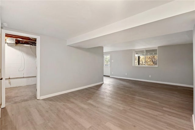 interior space featuring baseboards and wood finished floors